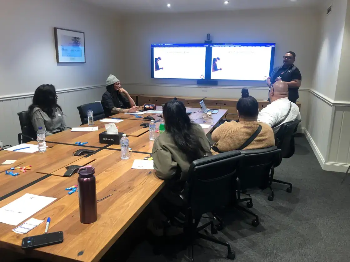 A South East Staffing presenter speaking to a group seated around a boardroom table